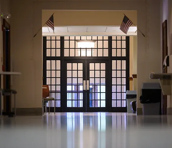 Double doors at the end of a hallway