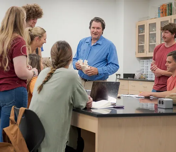 Science professor speaking to a group of students